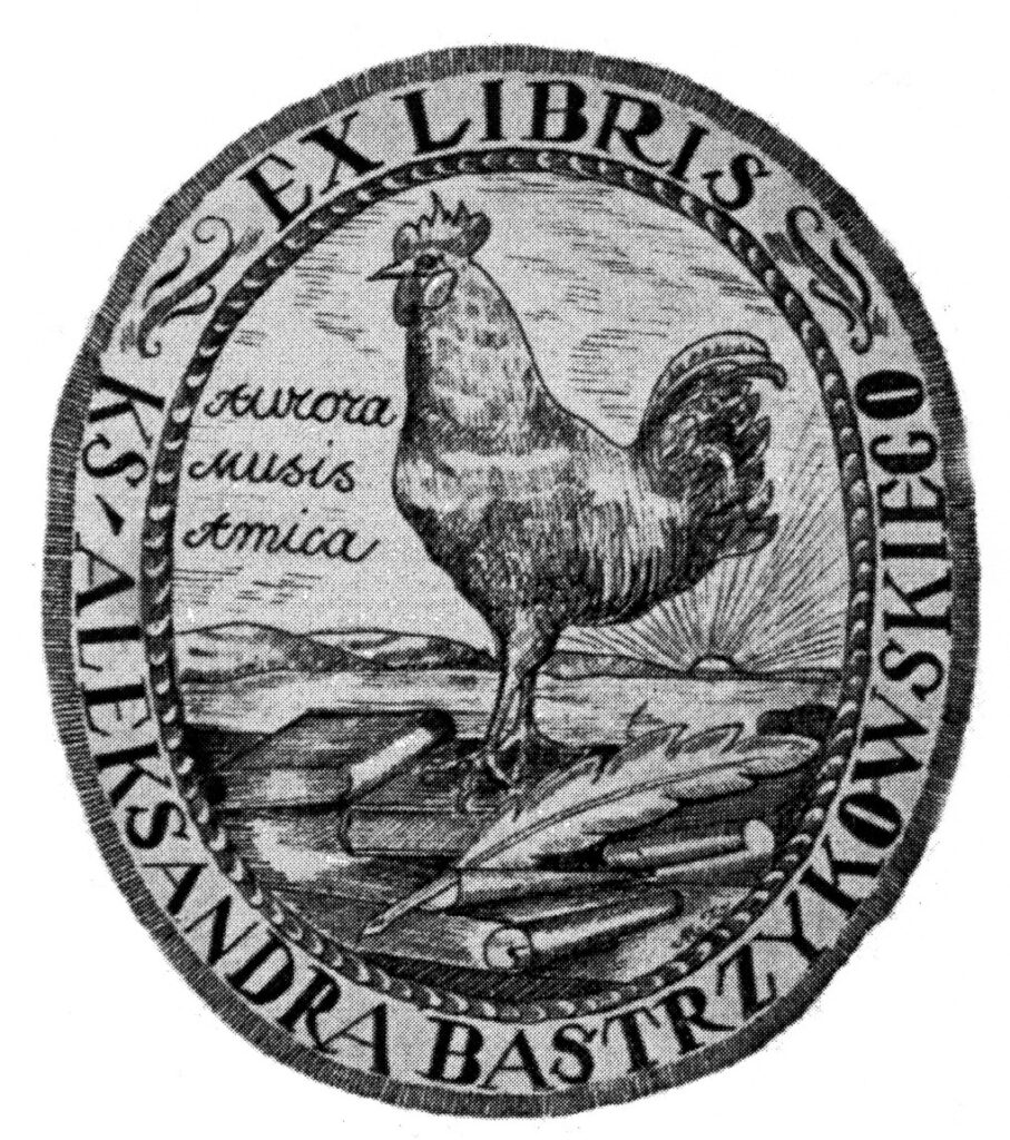 Ekslibris w formie stojącego owalu, w centrum kogut ukazany z lewej strony, stojący na książkach obok napis AURORA MUSIS AMICA, wokół otok z napisem EX LIBRIS KS ALEKSANDRA BASTRZYKOWSKIEGO